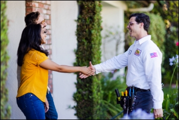 Mister Sparky employee with customer