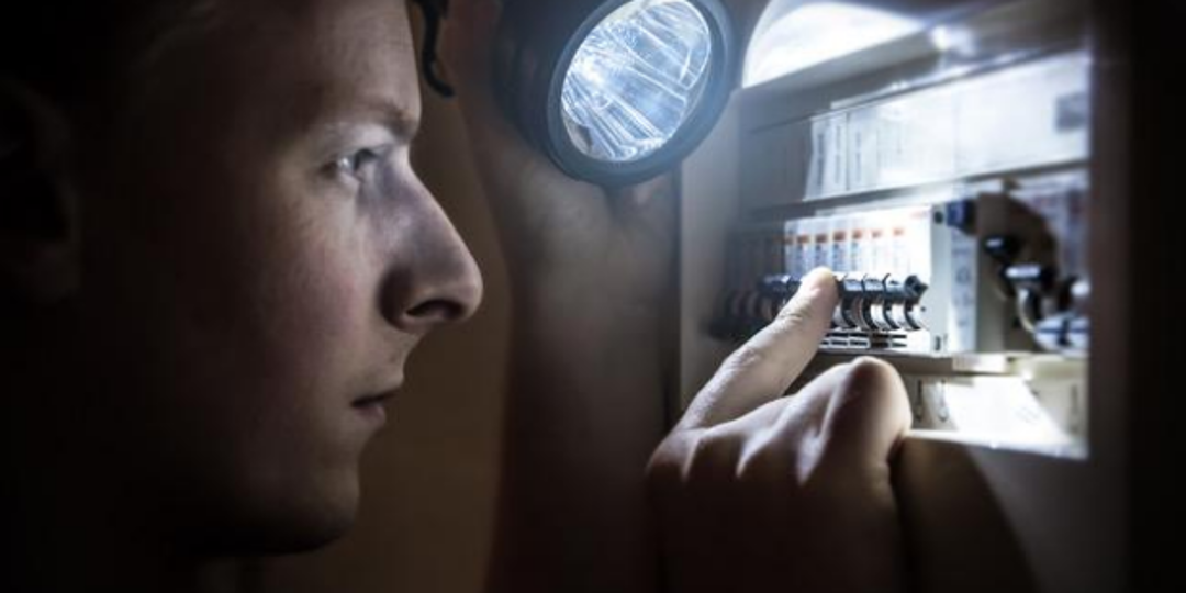 tech looking at circuit breaker