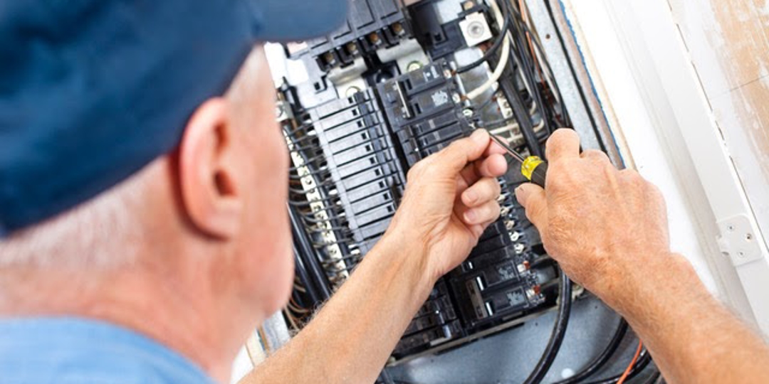 electrician working on circuit breaker