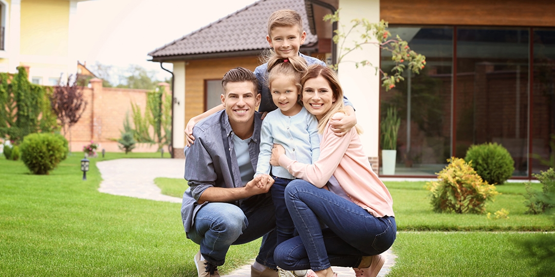 family in front of home