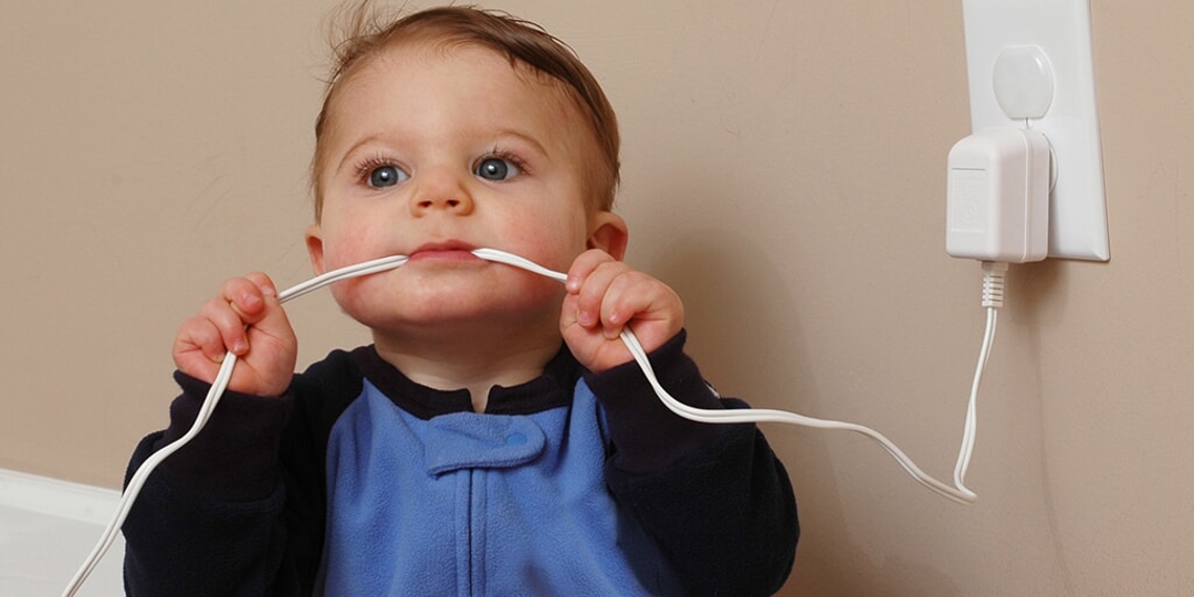 A baby protected from electrical danger