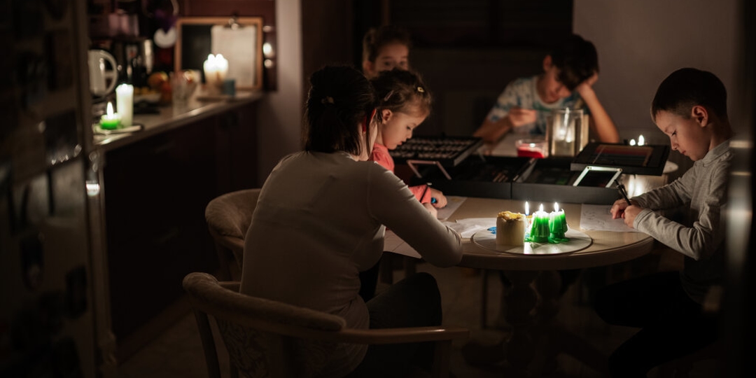 Family sitting in dark from a Power outage