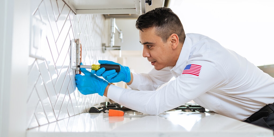 An Electrician fixing an outlet