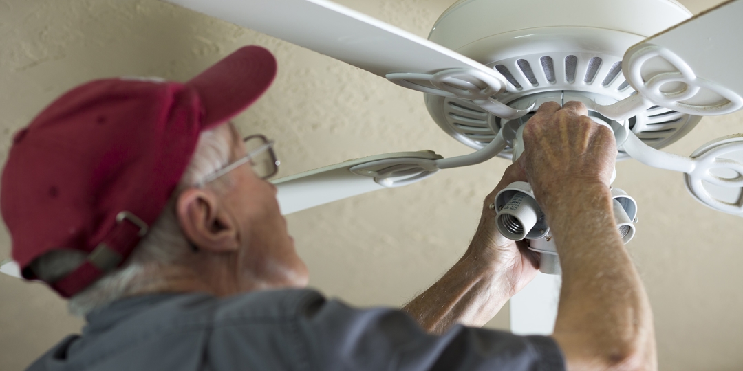man working on ceiling fan