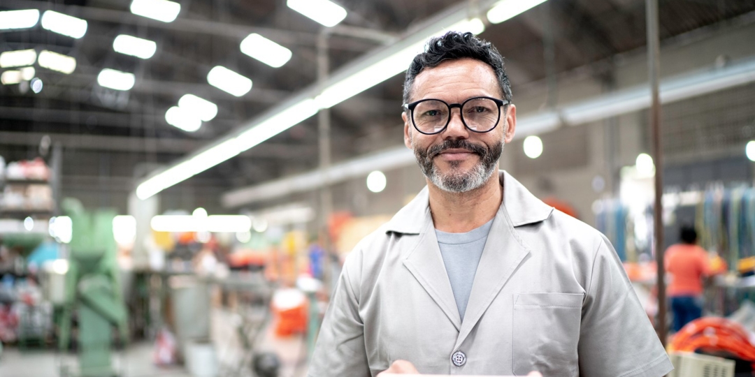 Man standing in facility smiling