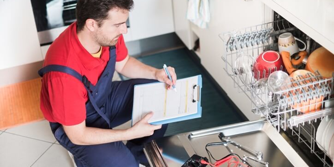 Image of electrician inspecting dishwasher