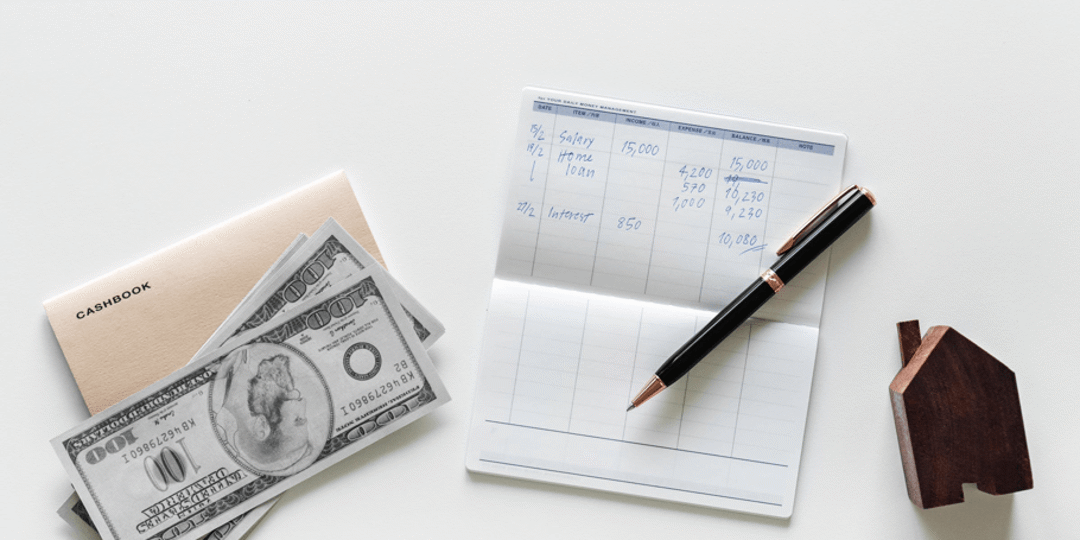 Cash, check book, and pen