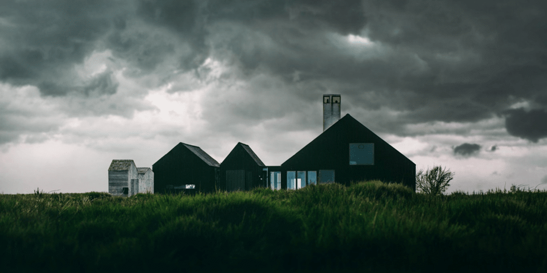 House with dark hurricane clouds in the background