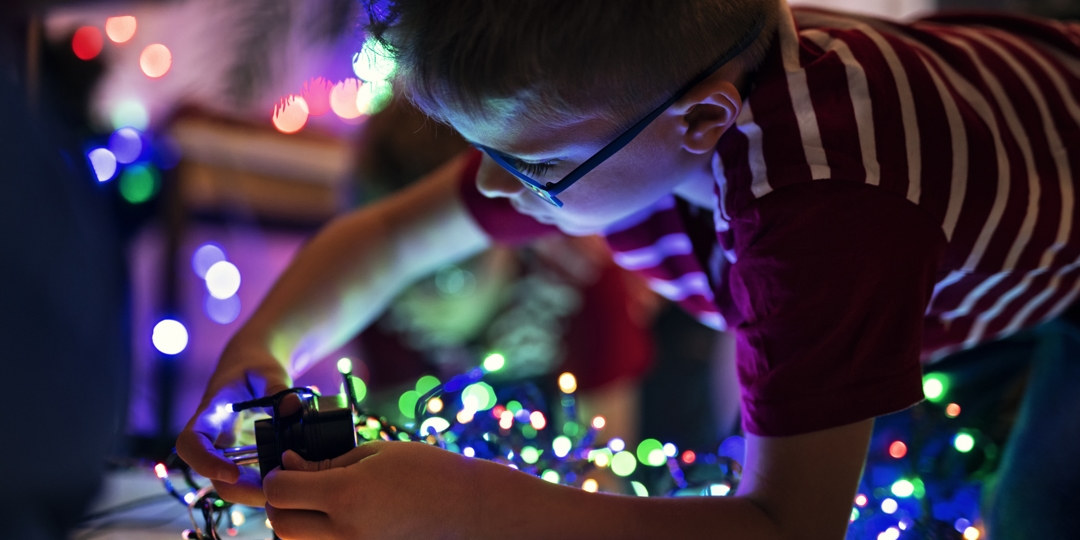 child with holiday lights