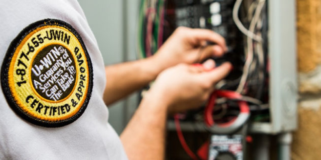 Electrician looking at wiring in panel