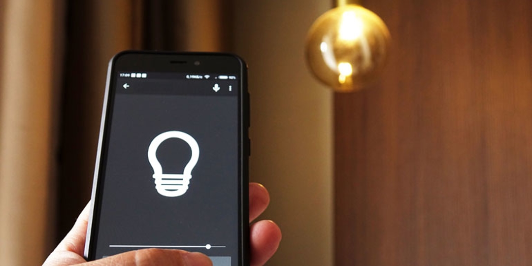 Person using an app on their cell phone to operate the lights