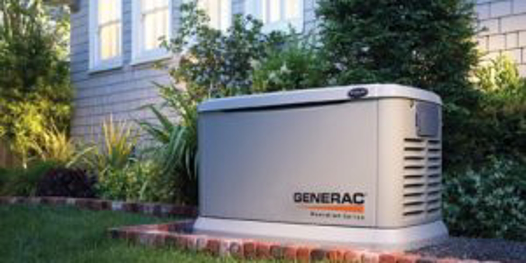 A grey stand up generator stationed in the back of a home