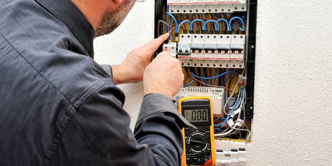 Electrician fixing electrical panel