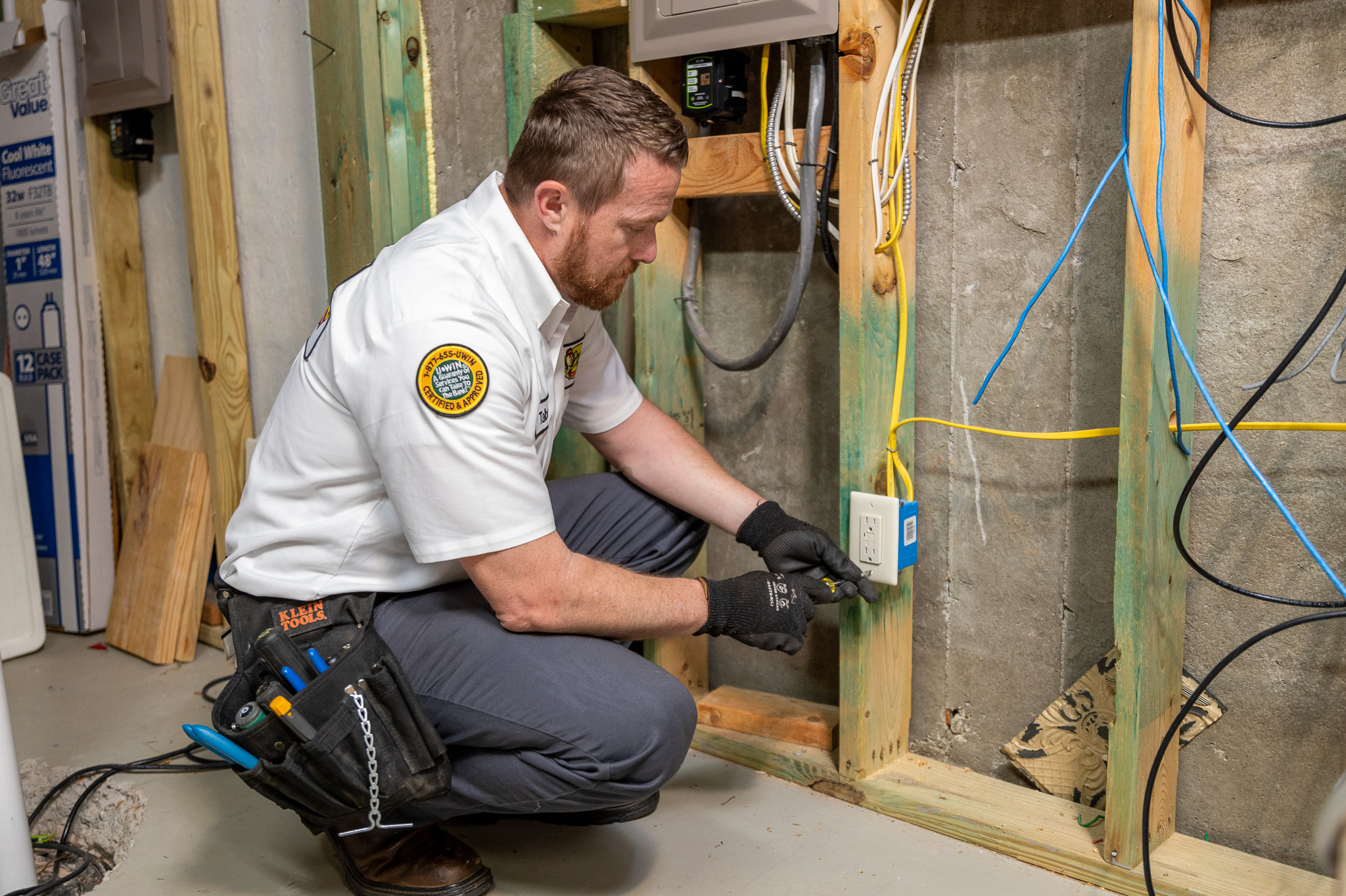 tech adjusting power outlet in attic