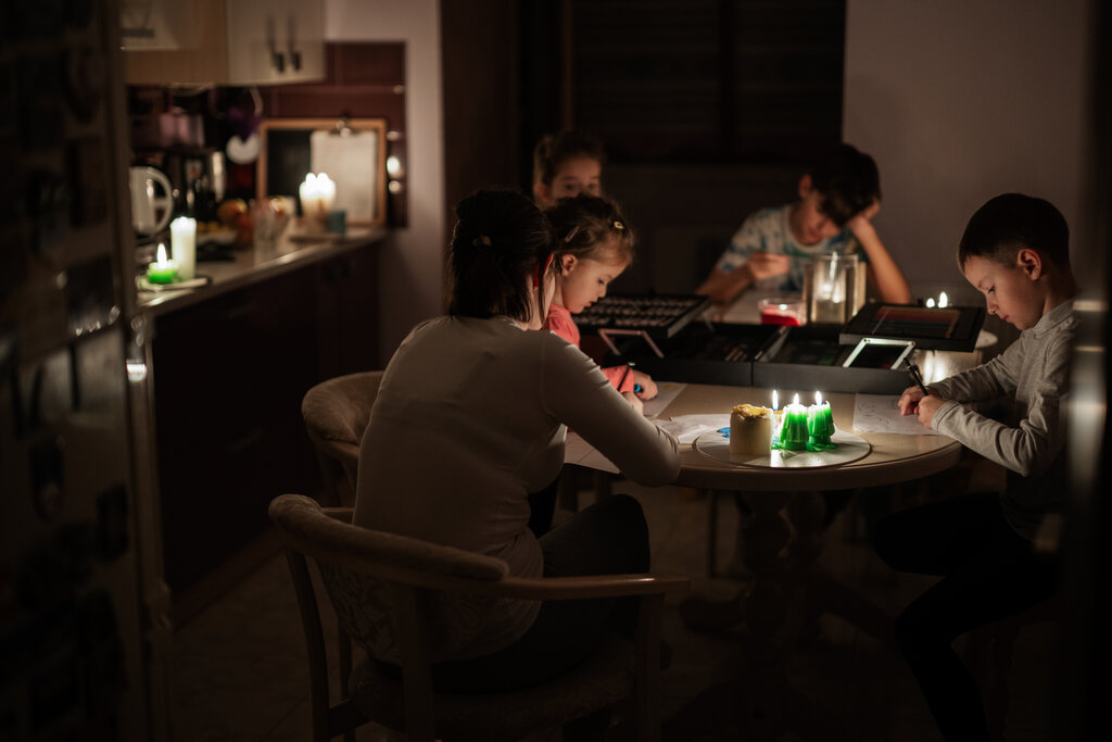 Family sitting in dark from a Power outage