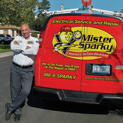 Mister Sparky tech standing next to van